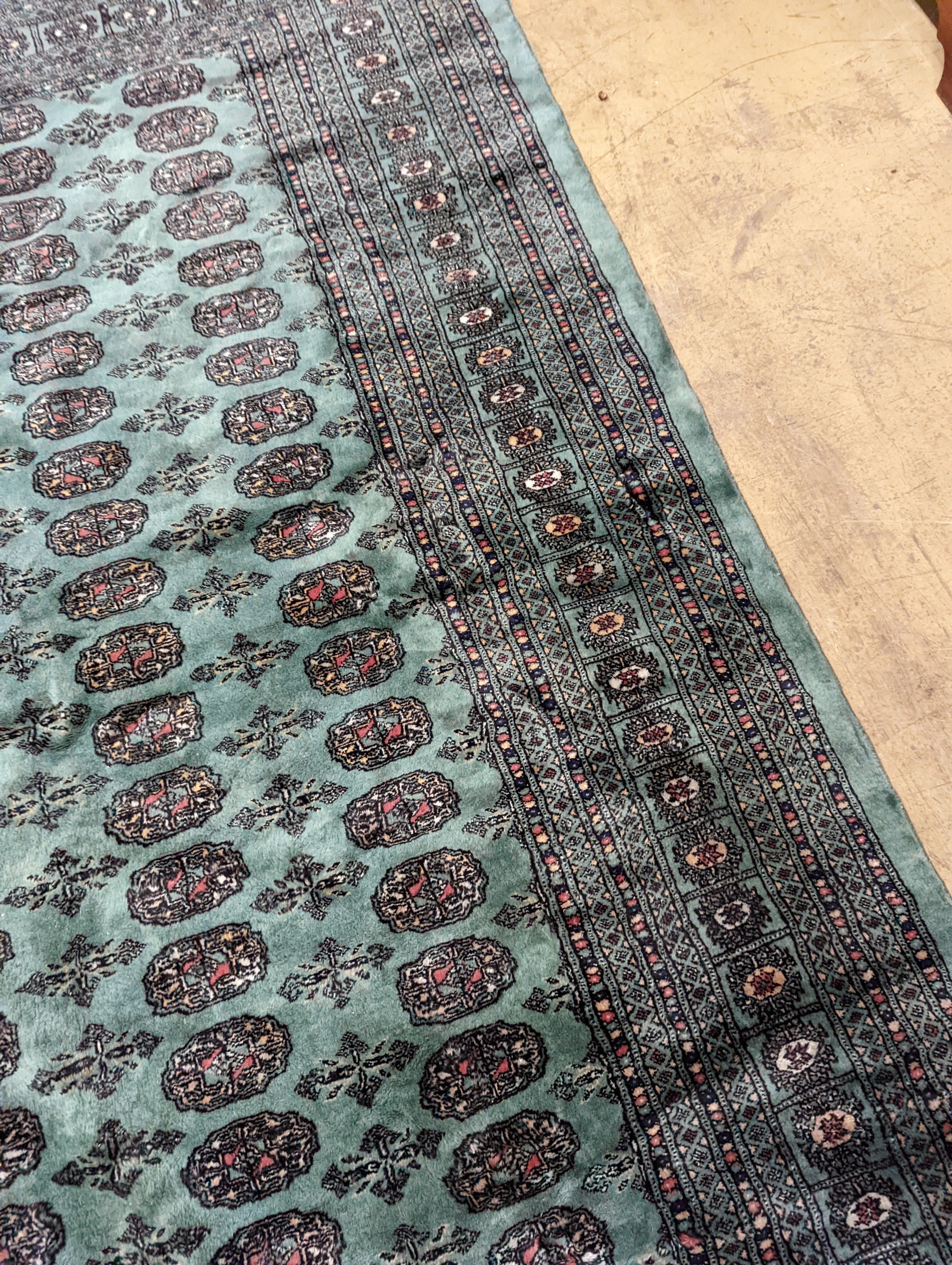A Bokhara green ground carpet, 282 x 184cm
